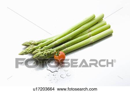 Water drops on asparagus and a cherry tomato View Large Photo Image Picture - Water drops on asparagus and a cherry tomato. Fotosearch