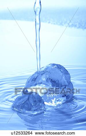 Water pouring on glasses, blue background View Large Photo Image Picture - Water pouring on glasses, blue background. Fotosearch