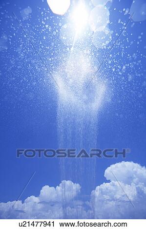 Stock Image - Water splashing against blue sky. Fotosearch