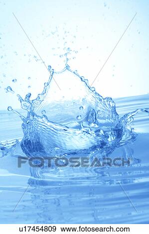 Stock Photo - Water splashing, close up, blue background. Fotosearch