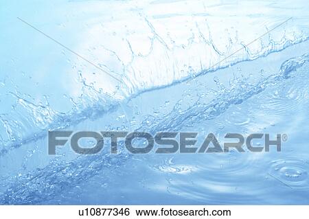 Stock Photograph - Water splashing, close up, blue background. Fotosearch
