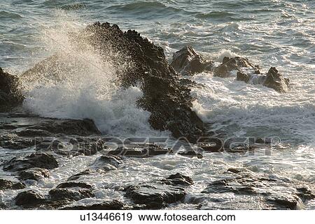 Wave crashing against rock View Large Photo Image Stock Photo - Wave crashing against rock. Fotosearch