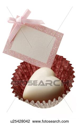 White chocolate heart in a cupcake wrapper with a gift tag attached View Large Photo Image Stock Image - White chocolate heart in a cupcake wrapper with a gift tag attached. Fotosearch