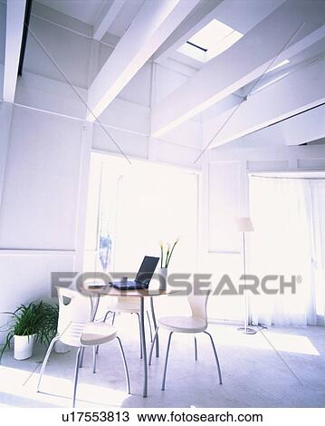 Stock Image - White room with table and laptop. Fotosearch
