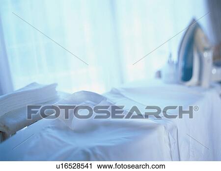 Stock Image - White shirt on an ironing board. Fotosearch
