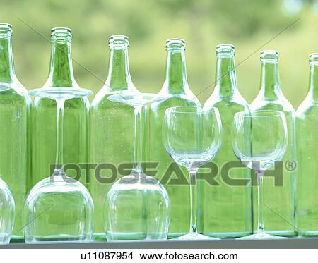 Wine bottles and wineglasses in a row View Large Photo Image Picture - Wine bottles and wineglasses in a row. Fotosearch