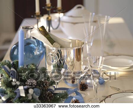 Wine in ice bucket on table during Christmas View Large Photo Image Stock Photo - Wine in ice bucket on table during Christmas. Fotosearch