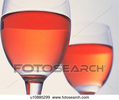 Stock Photo - Wineglasses full of orange liquid. Fotosearch