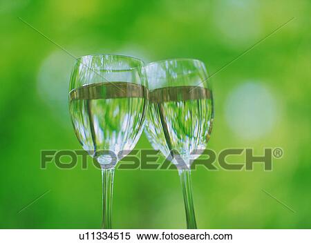 Wineglasses full of water toasting View Large Photo Image Stock Photography - Wineglasses full of water toasting. Fotosearch
