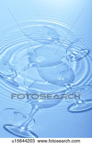 Wineglasses in water, blue background View Large Photo Image Stock Image - Wineglasses in water, blue background. Fotosearch