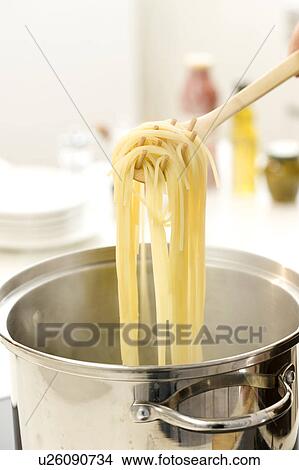 Picture - Woman boiling pasta. Fotosearch