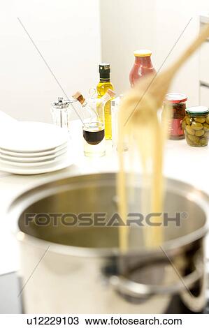 Woman boiling pasta View Large Photo Image Stock Image - Woman boiling pasta. Fotosearch