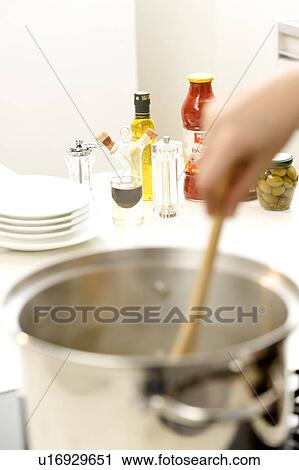 Woman boiling pasta View Large Photo Image Stock Image - Woman boiling pasta. Fotosearch