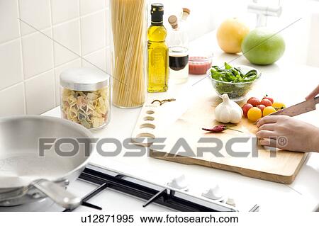 Stock Photography - Woman cutting vegetables. Fotosearch