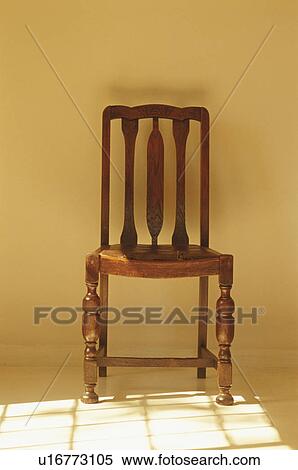 Wooden chair next to shadow cast by window View Large Photo Image Stock Photography - Wooden chair next to shadow cast by window. Fotosearch
