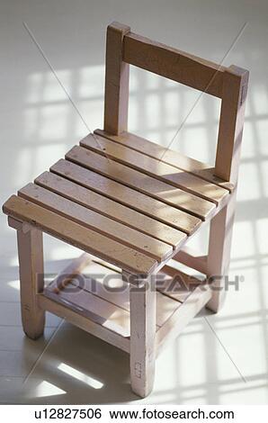 Stock Photograph - Wooden chair with shadow from window. Fotosearch