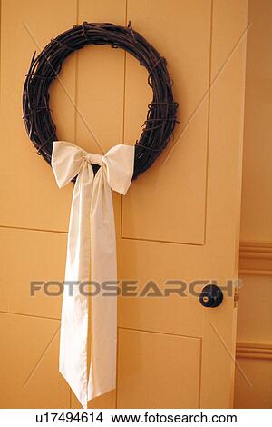 Wreath hanging on a yellow door View Large Photo Image Picture - Wreath hanging on a yellow door. Fotosearch