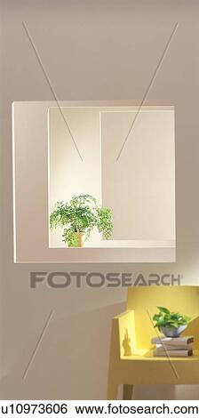 Stock Photograph - Yellow chair with books and pot plants. Fotosearch