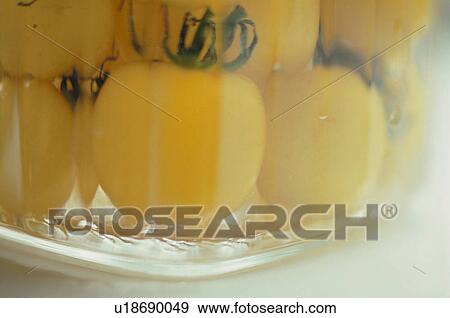 Stock Photo - Yellow cherry tomatoes in glass bowl. Fotosearch