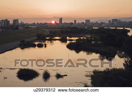 Stock Image - Yodogawa River at sunset. Asahi-ku, Osaka, Japan. Fotosearch