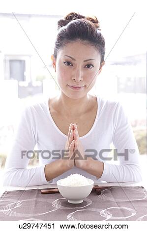 Young Woman at Table with Praying Hands View Large Photo Image Stock Image - Young Woman at Table with Praying Hands. Fotosearch