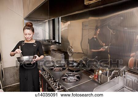 Young Woman Cooking at Kitchen in Restaurant View Large Photo Image Stock Image - Young Woman Cooking at Kitchen in Restaurant. Fotosearch