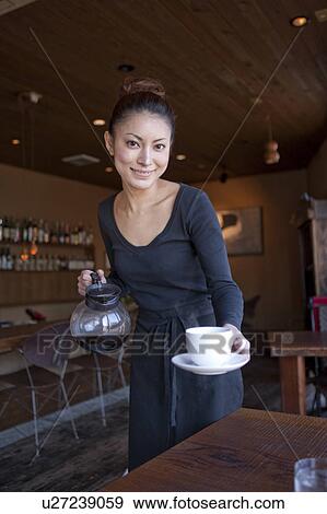 Stock Photo - Young Woman Holding Coffee Cup. Fotosearch