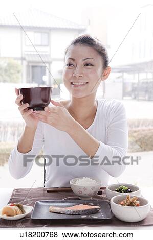 Stock Photo - Young Woman Holding Miso Soup Bowl. Fotosearch