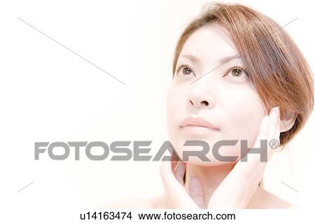 Young Woman Looking Up with Her Hands at Cheek View Large Photo Image Picture - Young Woman Looking Up with Her Hands at Cheek. Fotosearch