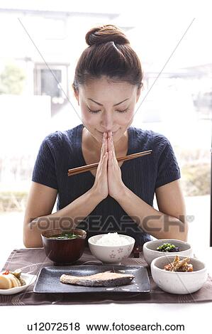 Young Woman Praying for Breakfast, Holding Chopsticks View Large Photo Image Stock Photo - Young Woman Praying for Breakfast, Holding Chopsticks. Fotosearch