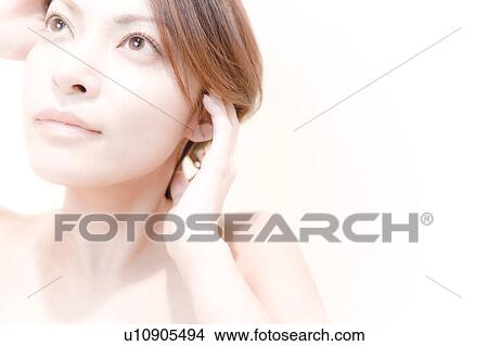 Picture - Young Woman Running Her Hands Through Her Hair. Fotosearch