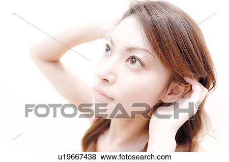 Stock Photo - Young Woman Running Her Hands Through Her Hair. Fotosearch