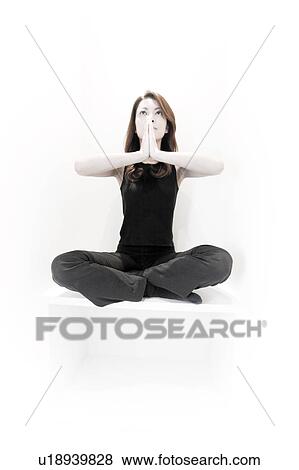 Stock Photo - Young Woman Seat in a Kneeling Position. Fotosearch