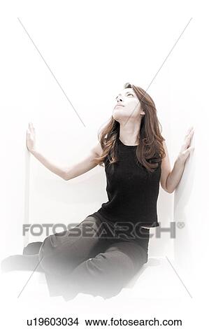 Young Woman Sitting Between White Walls View Large Photo Image Picture - Young Woman Sitting Between White Walls. Fotosearch