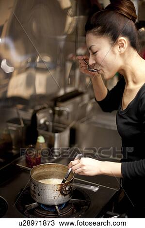 Young Woman Tasting at Kitchen in Restaurant View Large Photo Image Stock Image - Young Woman Tasting at Kitchen in Restaurant. Fotosearch