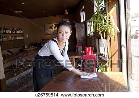 Picture - Young Woman Wiping Table. Fotosearch