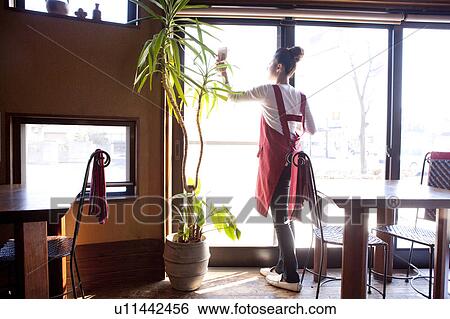 Stock Photograph - Young Woman Wiping Window. Fotosearch
