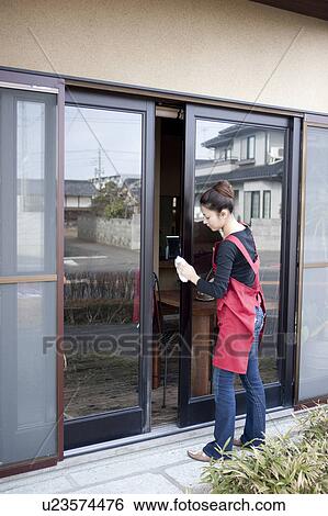 Stock Photograph - Young Woman Wiping Window. Fotosearch