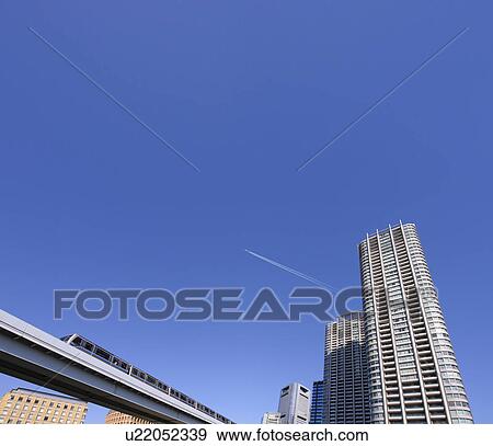 Stock Photo - Yurikamome and a super-high-rise tower apartment, Minato-ku, Tokyo, Japan. Fotosearch
