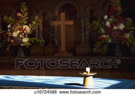 Candle, cross and flowers at an altar View Large Photo Image Stock Photo - Candle, cross and flowers at an altar. Fotosearch
