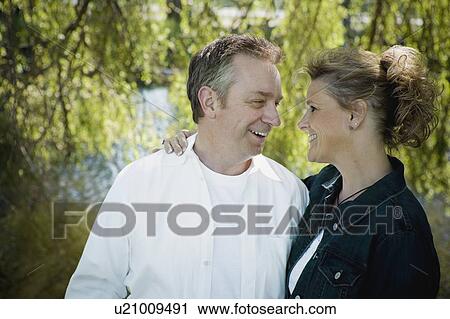 Happy couple smiling at each other View Large Photo Image Stock Image - Happy couple smiling at each other . Fotosearch