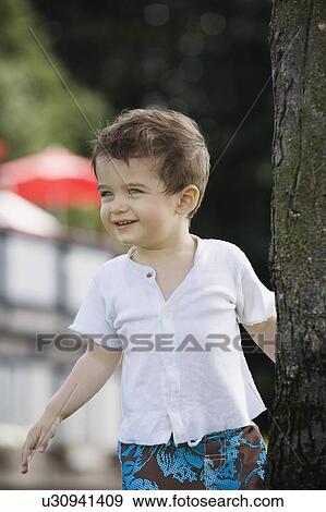 Stock Photo - Little boy playing outside . Fotosearch