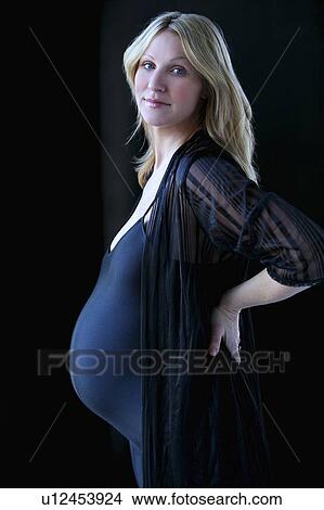 Picture - Pregnant woman in black leotard. Fotosearch