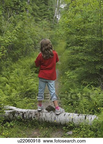 Young girl standing on log, Lake of the Woods, Ontario, Canada View Large Photo Image Stock Photo - Young girl standing on log, Lake of the Woods, Ontario, Canada. Fotosearch
