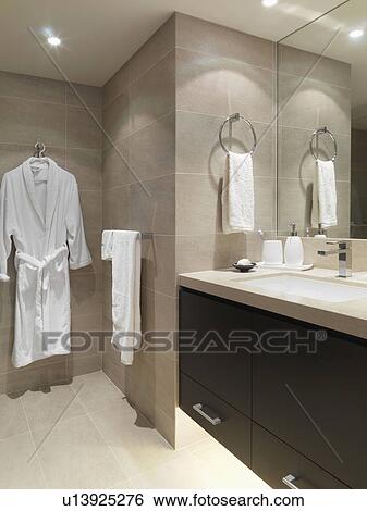 Stock Photograph - Bathrobe hanging in modern bathroom. Fotosearch
