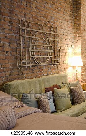 Stock Photograph - Bed and sofa in small studio apartment. Fotosearch
