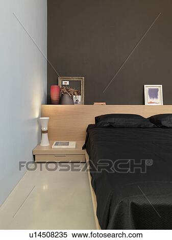 Stock Photography - Black platform bed in modern bedroom. Fotosearch