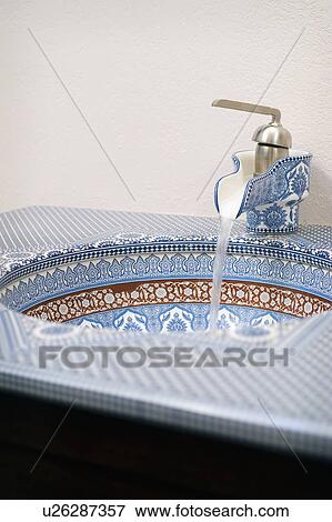 Stock Photo - Blue and red geometric patterned bathroom sink. Fotosearch
