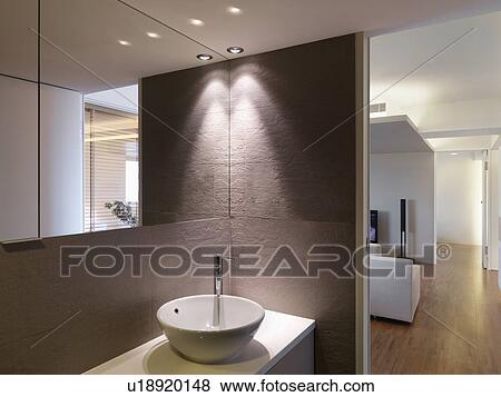 Stock Photo - Bowl sink in bathroom and hardwood floor leading down hallway. Fotosearch