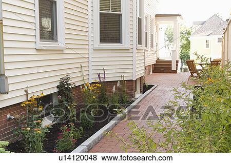 Stock Photo - Brick walkway along side of home. Fotosearch